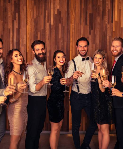 Group of friends toasting to becoming year in the club